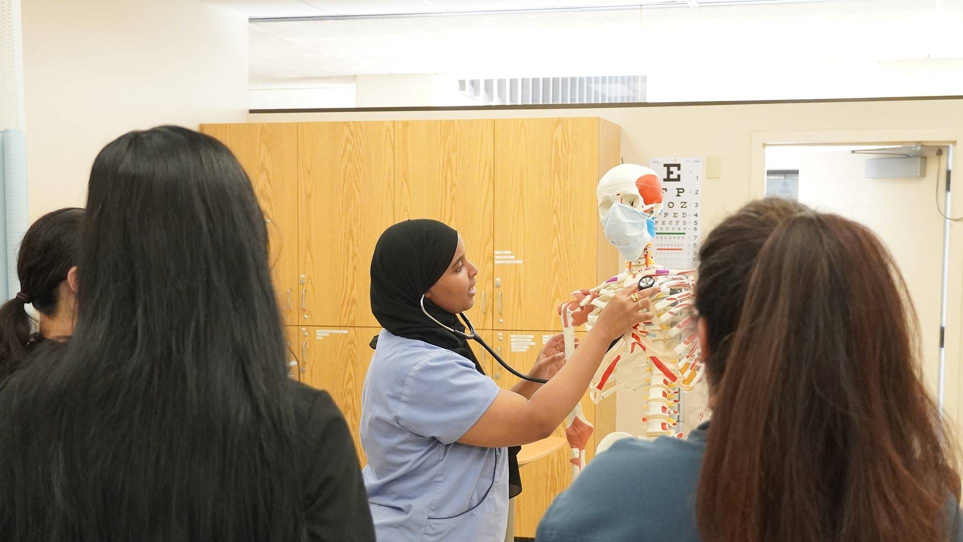 Nurse Professor teaching bone anatomy to students