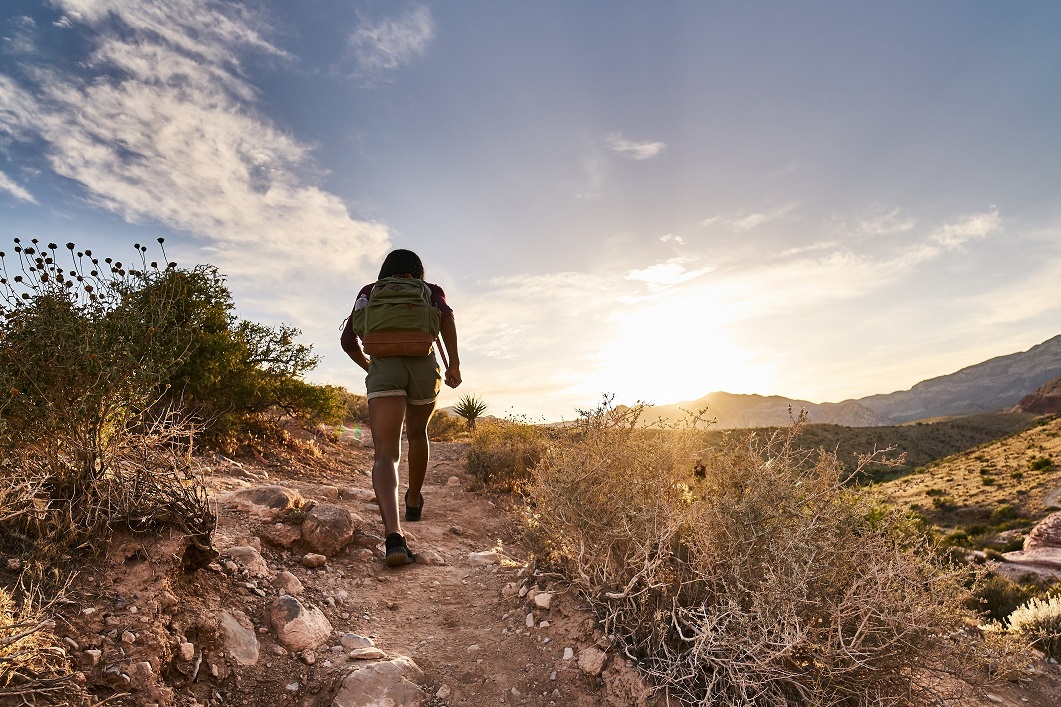 Person solo hiking in the sunset